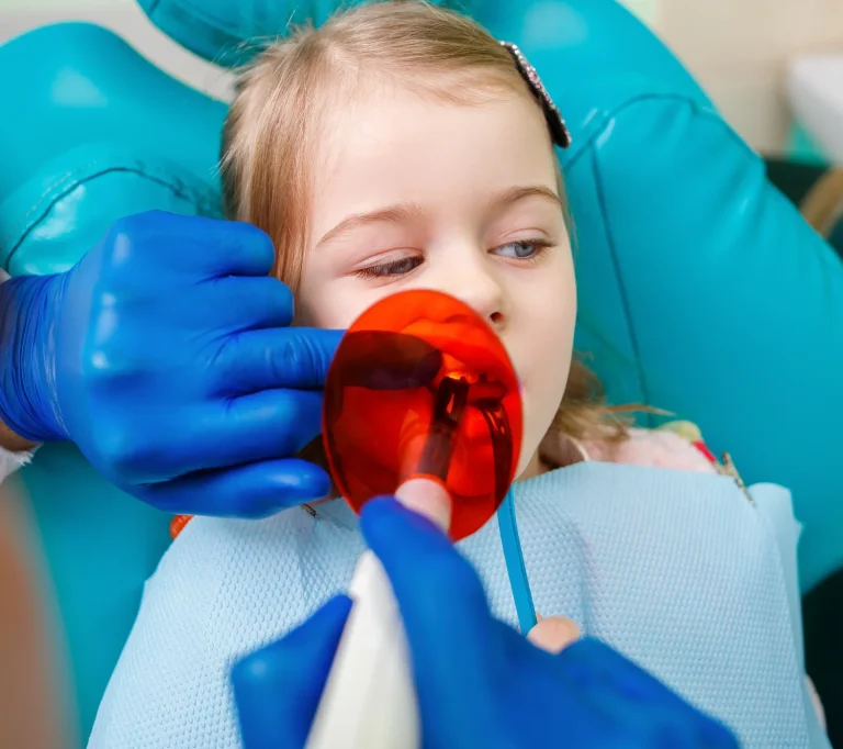 Dentist examining young patient