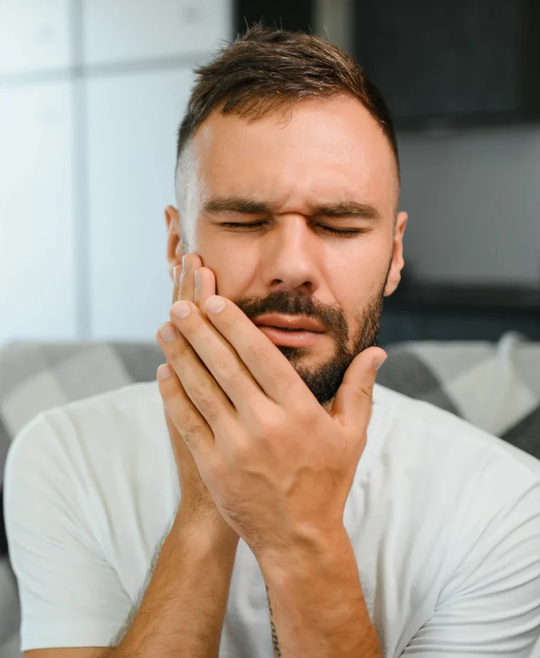 Man holding painful cheek