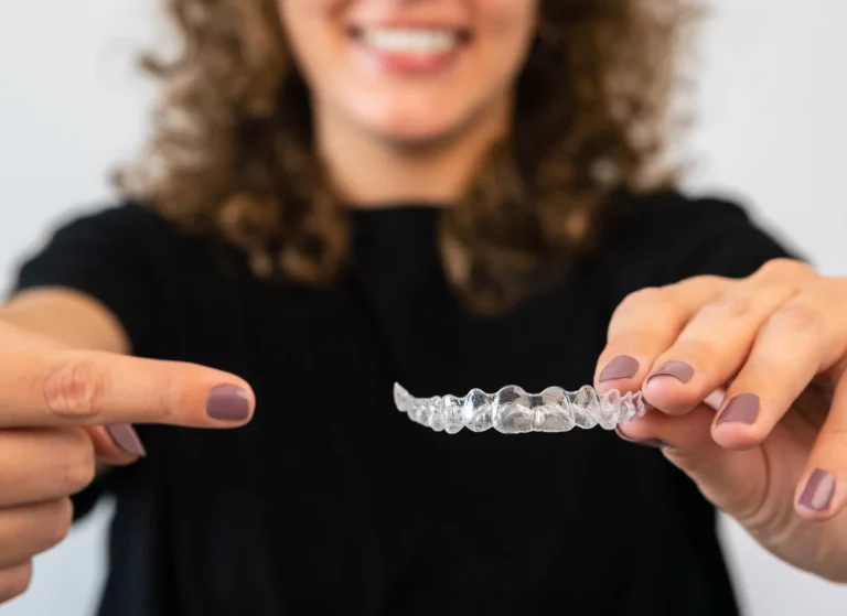Patient holding clear aligners