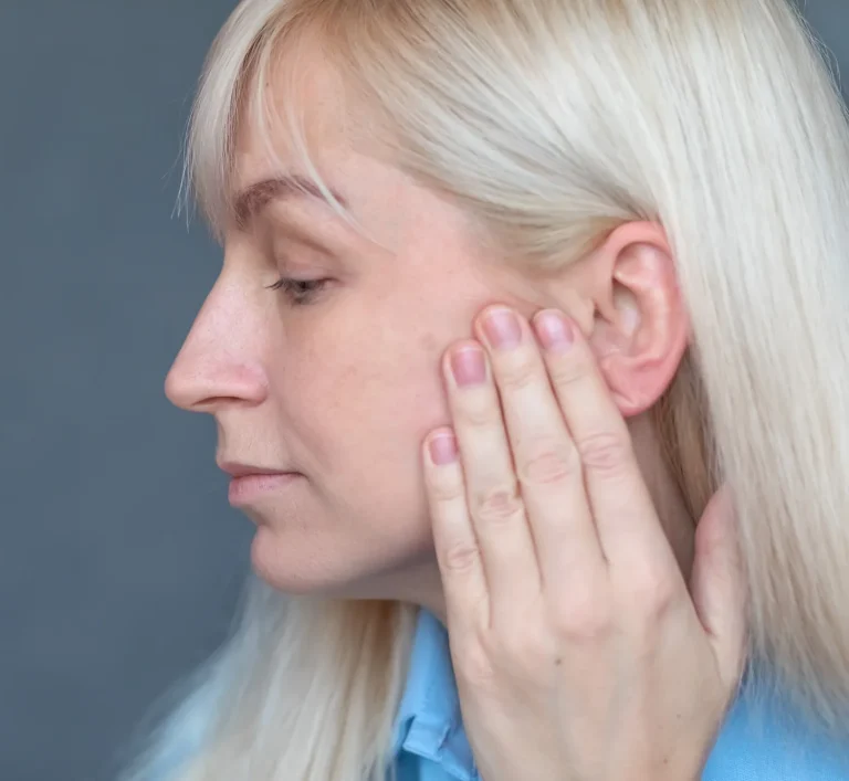 Woman holding painful jaw
